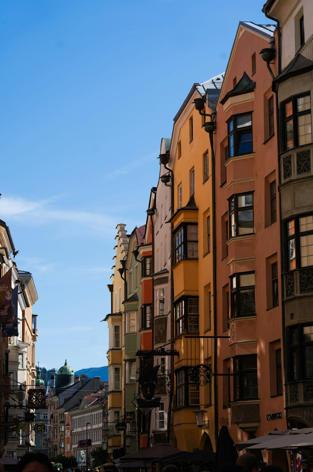 Row of colourful residential apartment buildings in a dense European city