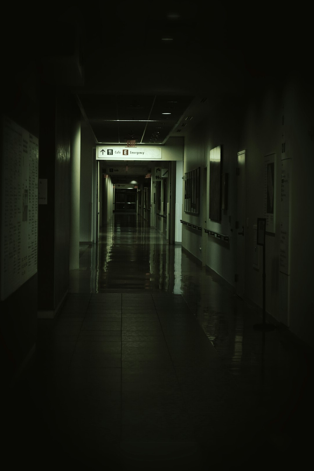 Empty hospital corridor with chairs along the wall