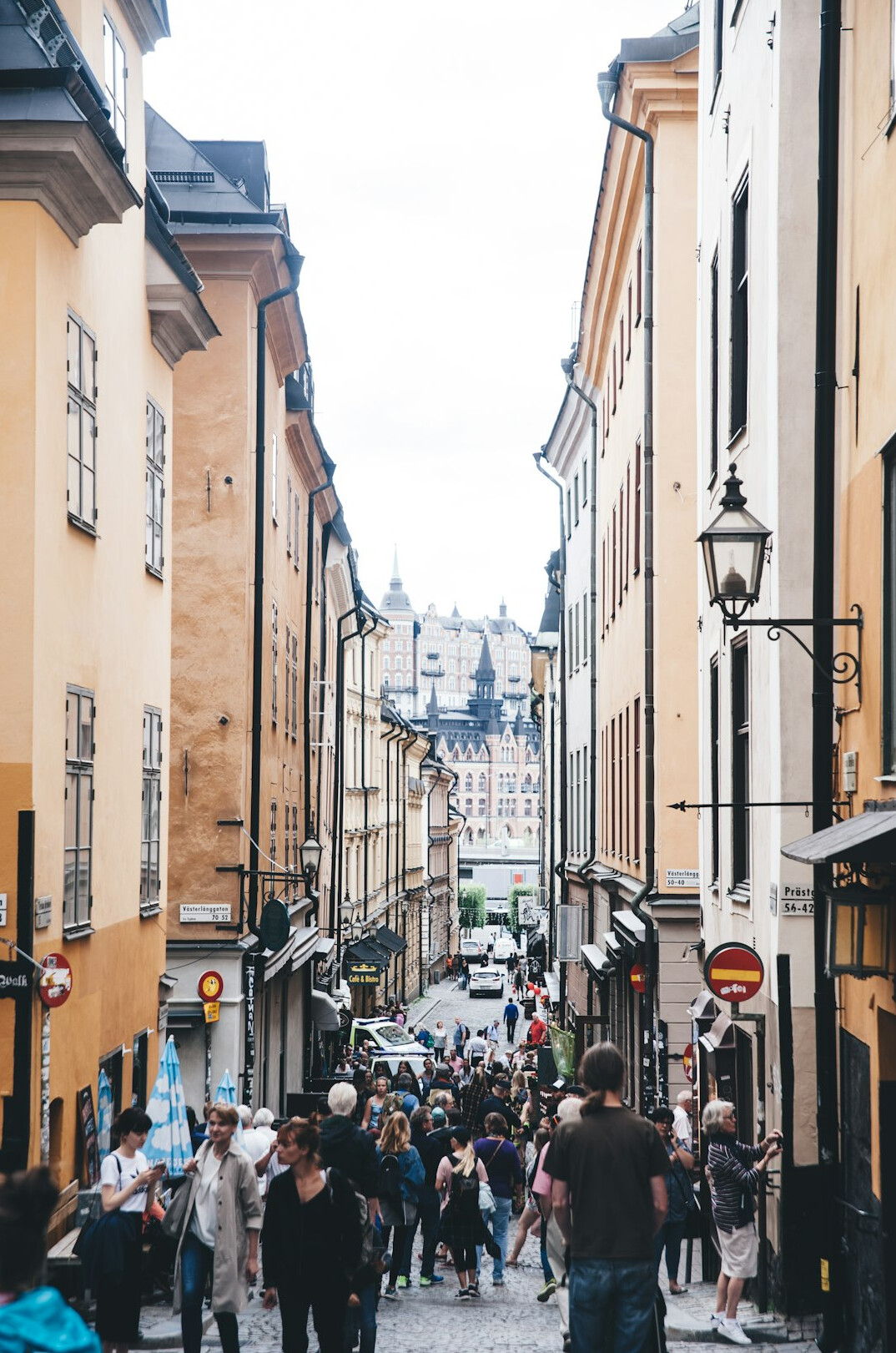 Crowded narrow street with tourists in a historic European city centre