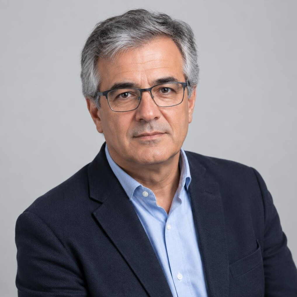 Studio portrait of a Portuguese man in his fifties with grey hair and glasses